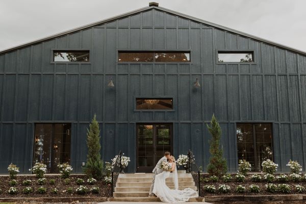 Photo of newlywed couple in front of the Legacy taken by Haley McElroy.