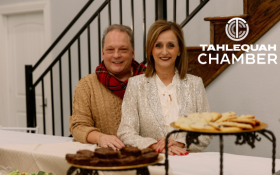 Danny and Michelle, owners of Vidalia's Cafe & Catering are smiling beside the brownies and cookies they have prepared for the event.